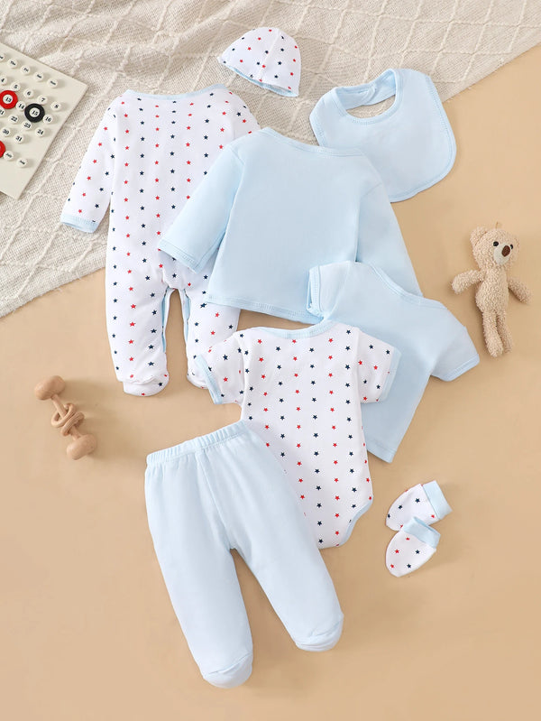 Eight-piece light-blue baby layette with star-print bodysuit, blue top and pants, bib, cap, mittens, and footed romper.