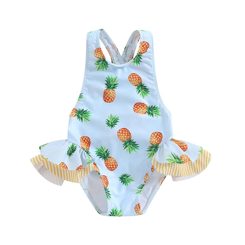 Light-blue pineapple-print toddler one-piece swimsuit with crisscross back and frilly yellow-striped leg ruffles.