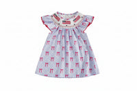Children's dress with bow pattern and American flag design on a beige background