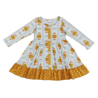 Cute long sleeve A-line dress featuring pumpkin and floral print with blue bow accents, yellow polka dot ruffle hem, and front buttons.