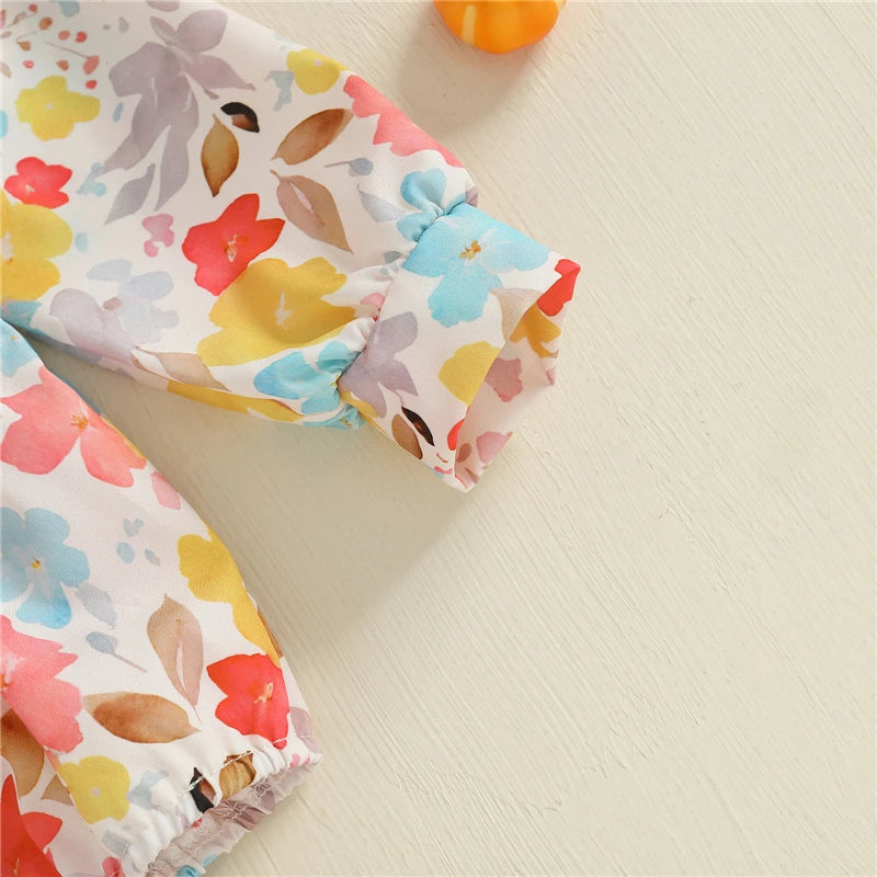 Close-up of the sleeve detail of the Fall Fabulous Pumpkin Embroidered Bubble romper, showing elastic cuffs and colorful floral patterns, ideal for comfort and style.