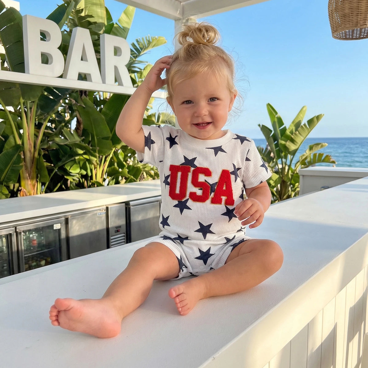 Close-up of the waffle-cut fabric of Freddie USA Embroidered Patriotic Romper for Toddlers, highlighting the soft texture and breathable design ideal for summer fun.