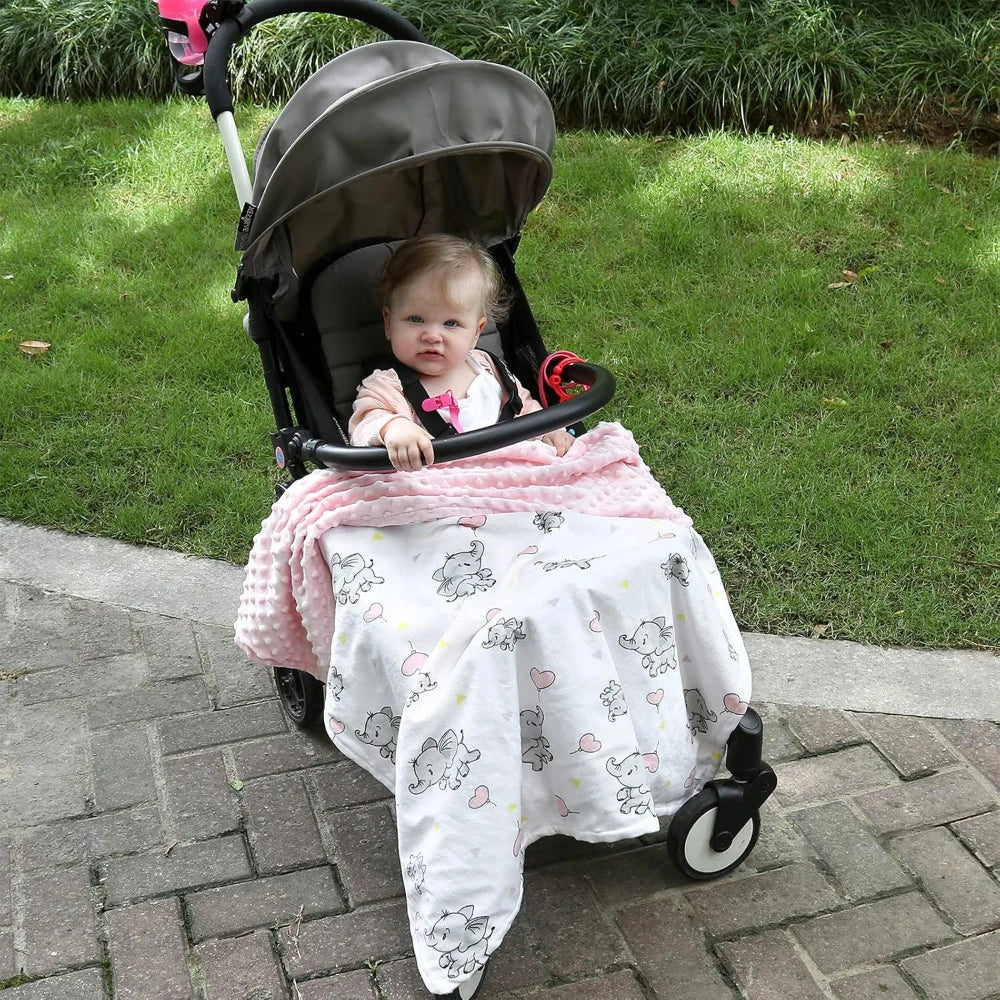Ellie Elephant pink lightweight baby blanket 30x40 draped on stroller with pink polka dots and elephant pattern.