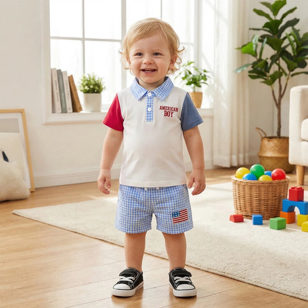 Toddler in American Boy patriotic polo shirt and blue gingham seersucker shorts with American flag patch