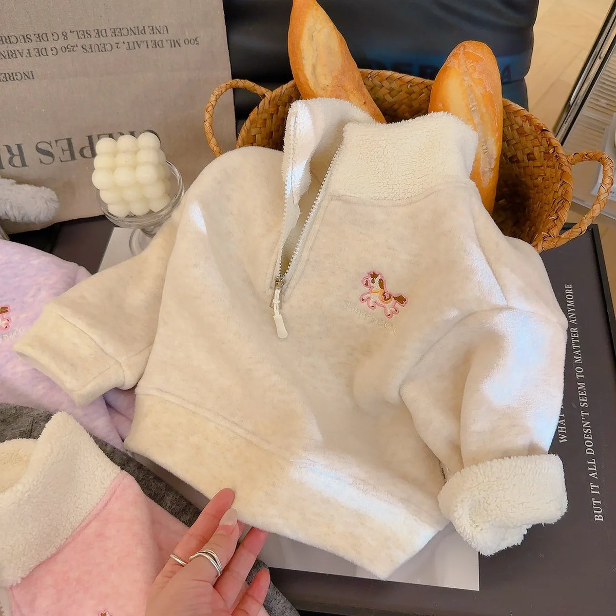Off-white children's cozy fleece pullover with embroidered horse zipper detail. Ultra-soft long-sleeve fall and winter top for boys and girls.