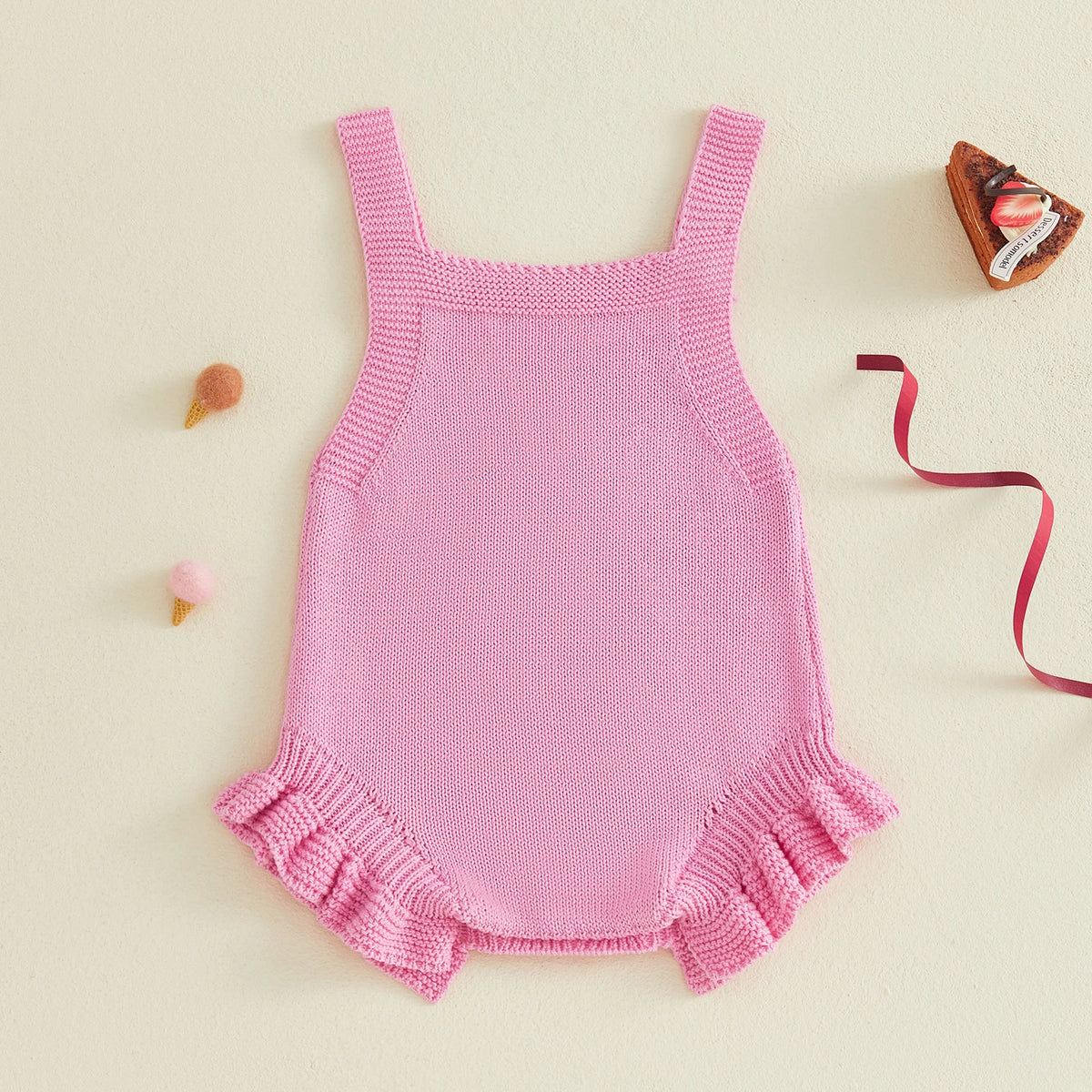 Pink knitted sleeveless baby romper overalls with frilly leg hems for girls