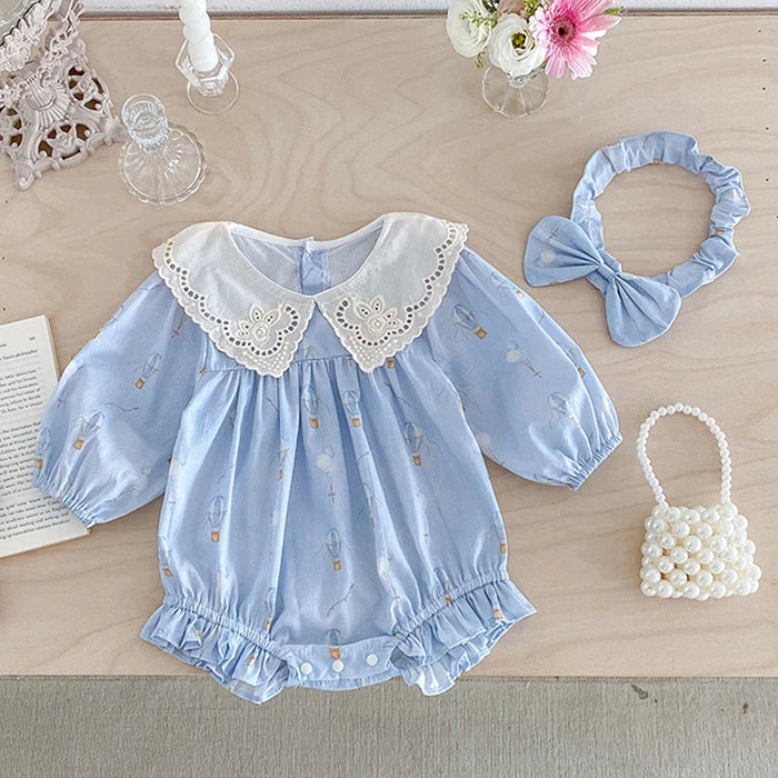 Up, Up and Away: Vintage Design Bubble featuring a blue cotton blend fabric with hot air balloon prints and a lace collar, styled with a headband and pearl handbag.