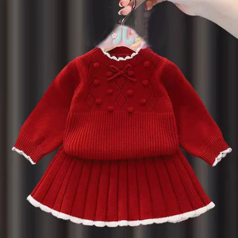 Cute Anna Knit Skirt Set for Girls with a stylish red pullover and pleated skirt, ideal for holiday celebrations and special occasions.