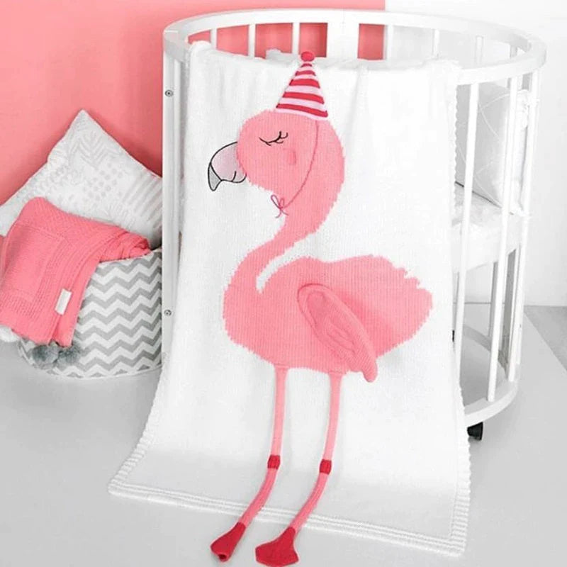A cozy pink flamingo blanket displayed in a crib, part of the 'Sleepy Tight' cute animal blankets for children.