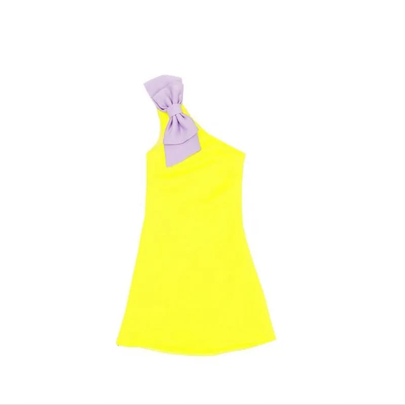 The 'Logan' Chic Kids Party Dress laid out flat, showcasing its vibrant yellow fabric and elegant purple bow detail, a perfect choice for chic kids party dress options.
