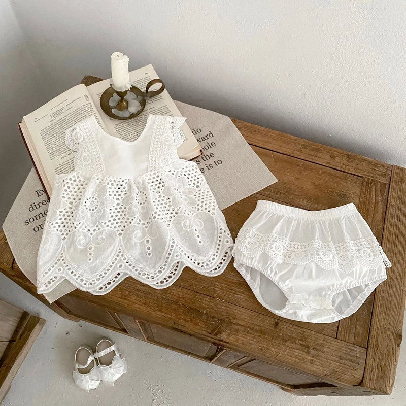 "Summer Sweet" Lace Baby's Romper arranged on a rustic wooden table, highlighting its charming lace top and matching bottom for stylish summer outings.