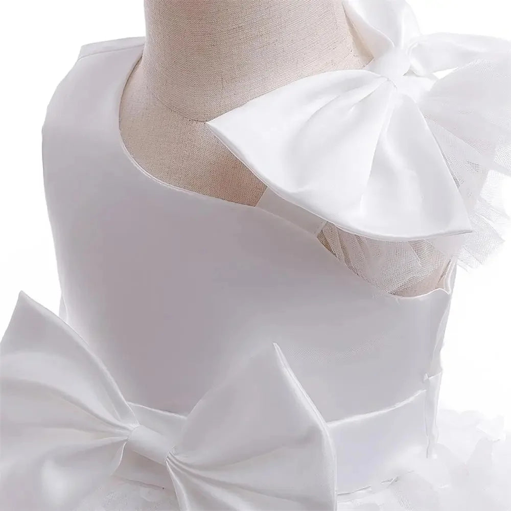 Butterfly Wishes formal dress on a mannequin; white satin gown with large bows and tulle accents.