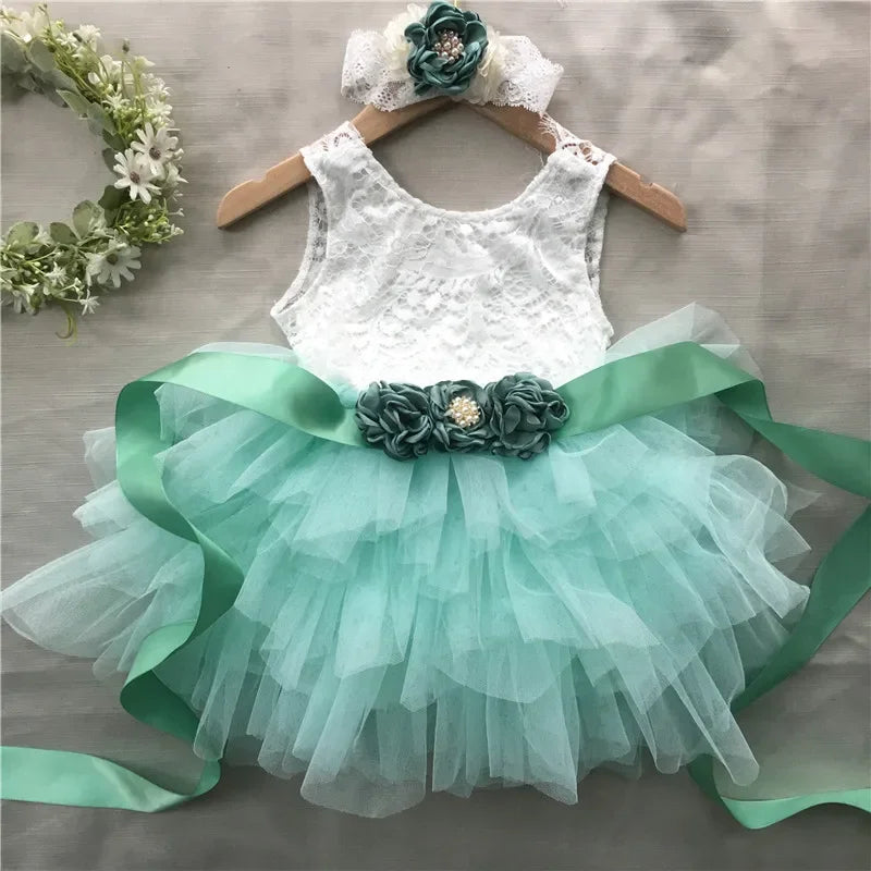 Elegant girls' beaded dress set: white lace bodice, mint tulle skirt, flower belt, and matching headband.