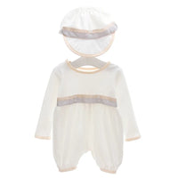 White formal baby boy romper set with matching hat. Features beige trim, decorative buttons, and long sleeves for special occasions.