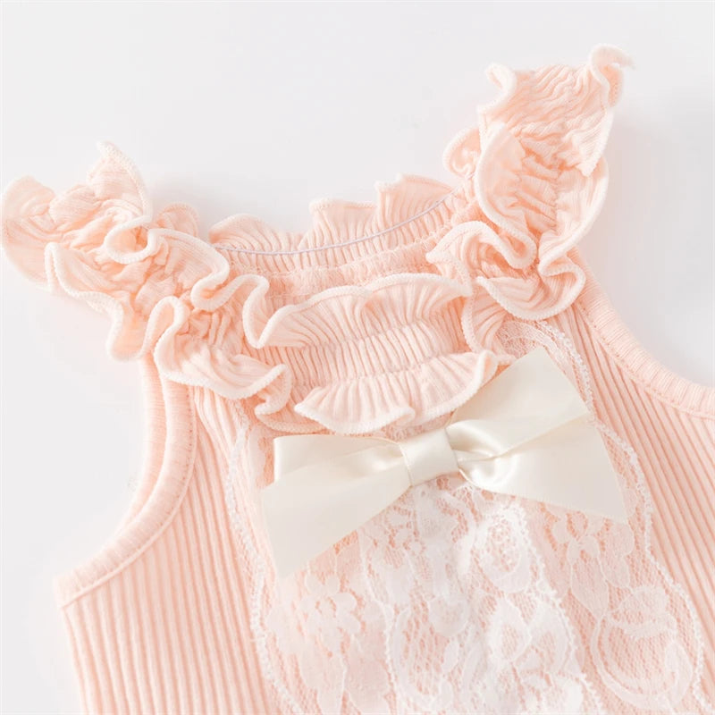 Close-up view of the Ruffle Baby! Adorable Knit Romper in princess pink, showcasing the ruffled straps and satin bow accent.