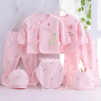 Playful giraffe-themed 7-piece pink newborn layette set with two tops, two pants, two bibs, and hats.