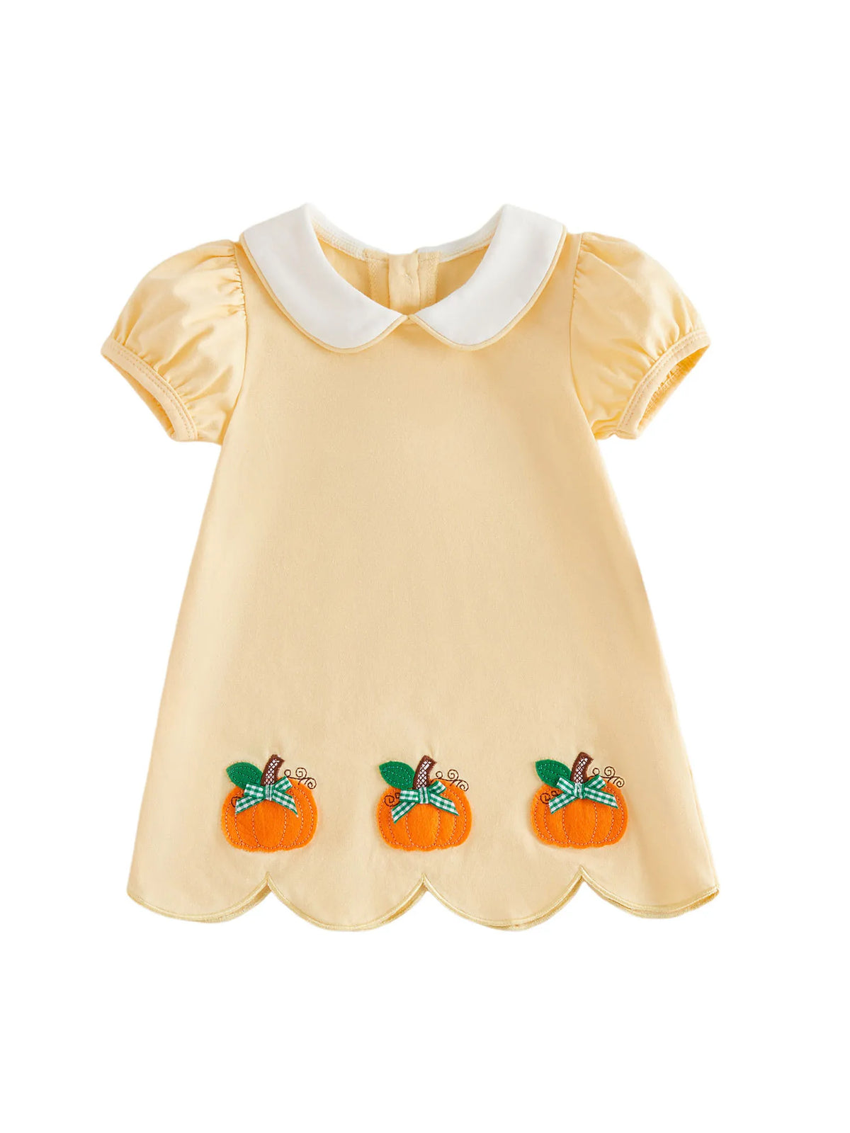 A pale yellow baby dress with a white Peter Pan collar, short puff sleeves, and three orange pumpkin patches with green leaves and blue bows near the hem, shown on a plain white background.