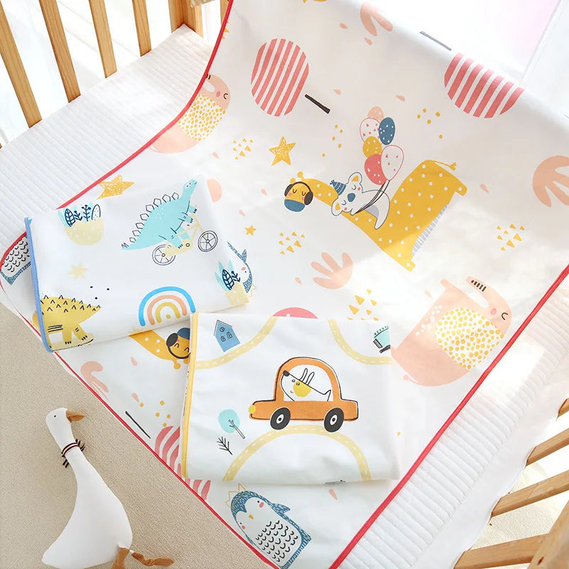 Children's waterproof changing pad cover with cute prints of cars, balloons, and animals on white.
