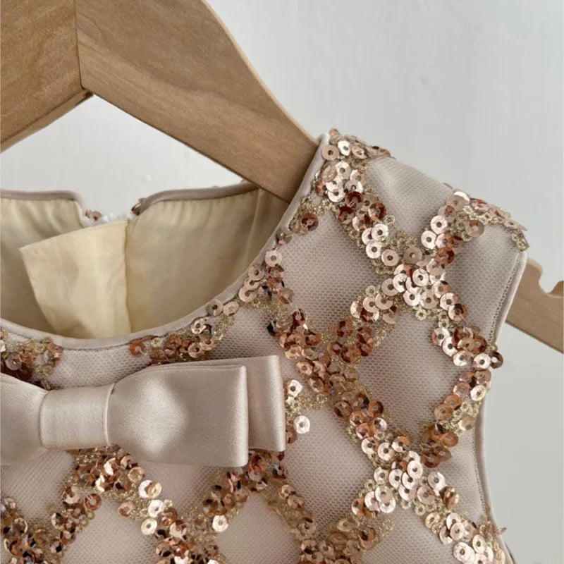 Close-up of the bow accent on the Isabella Elegant Sequined Dress for Little Girls in beige, highlighting its charming features.