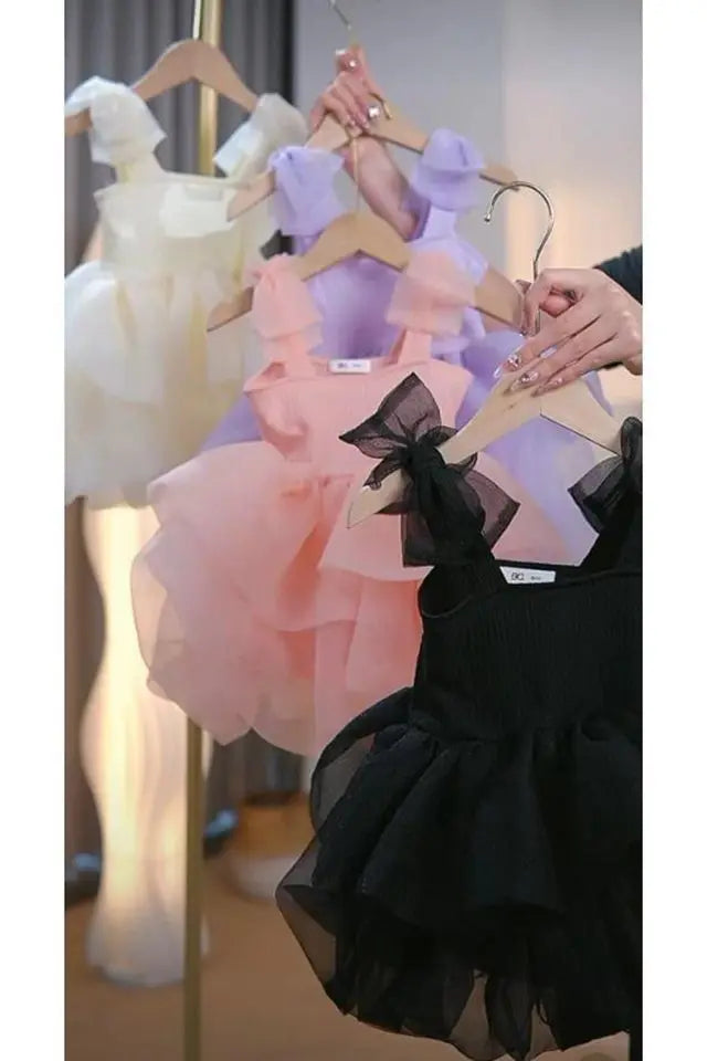 Collection of the Addie Tulle Dress for Girls in multiple colors including white, pink, purple, and black, showcasing these beautiful tulle dresses for girls.