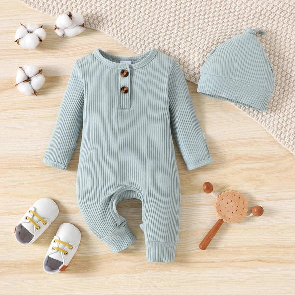 light blue ribbed romper with matching hat for baby laid flat with shoes and toys