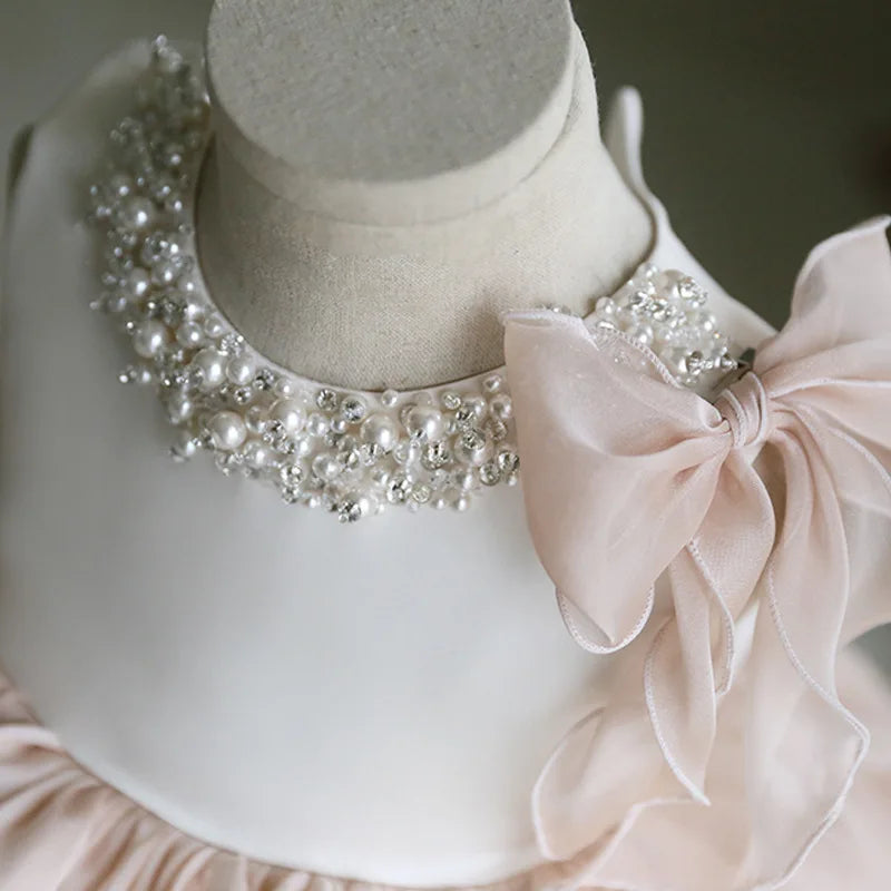 Detailed view of the Gwendolyn Tulle Special Occasion Dress - Chic Beige collar with pearl embellishments and a charming tulle bow for added whimsy.