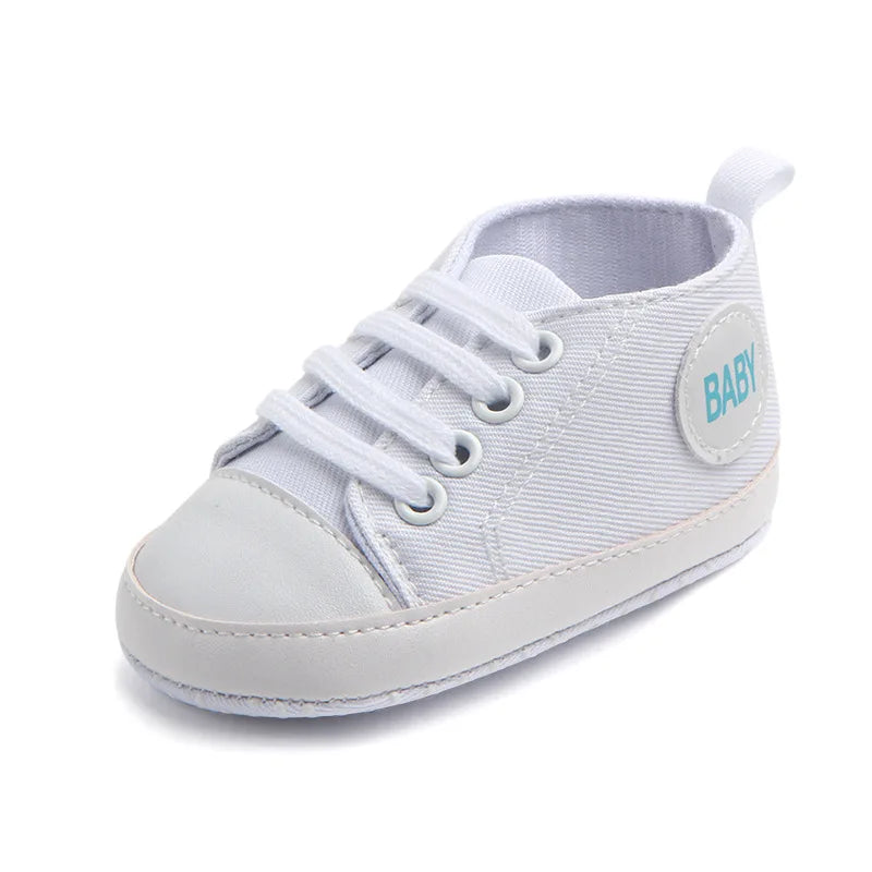 Baby's Canvas Lace-up Soft-Sole First Walkers in white, perfect for infants learning to walk.