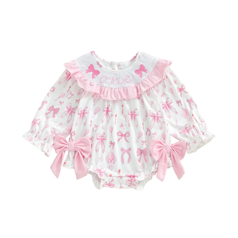 Baby romper with pink bows and ruffles on a white background