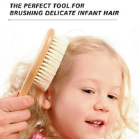 Wooden baby brush with soft bristles brushing a toddler's blonde hair.
