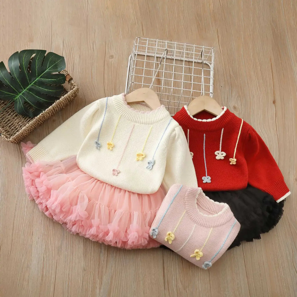 Little Flowers Fluffy Tulle Skirt 2 PC Outfits featuring a cozy pullover sweater and vibrant tulle skirt available in three delightful colors: holiday red, bubble gum pink, and creamy pink.