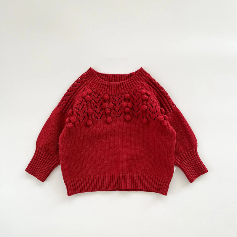 Detail of the deep red Popcorn Knit Pullover with puffed sleeves, paired with matching toddler skorts, for perfect toddler outfits.
