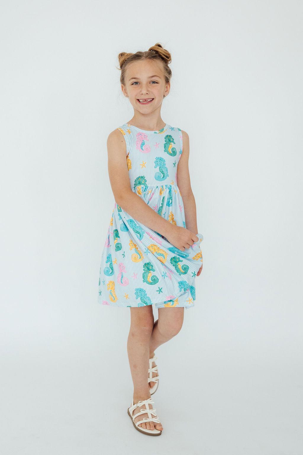 Back view of the Seahorse Swirl Tank Twirl Dress for girls, highlighting the scoop back design for easy dressing.
