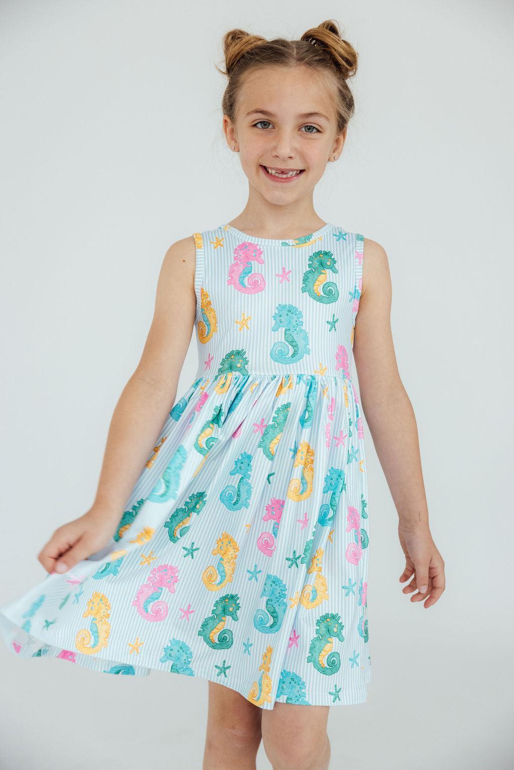 The Seahorse Swirl Tank Twirl Dress for girls styled with accessories, perfect for a fun day out or special occasion.