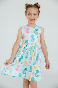 The Seahorse Swirl Tank Twirl Dress for girls styled with accessories, perfect for a fun day out or special occasion.