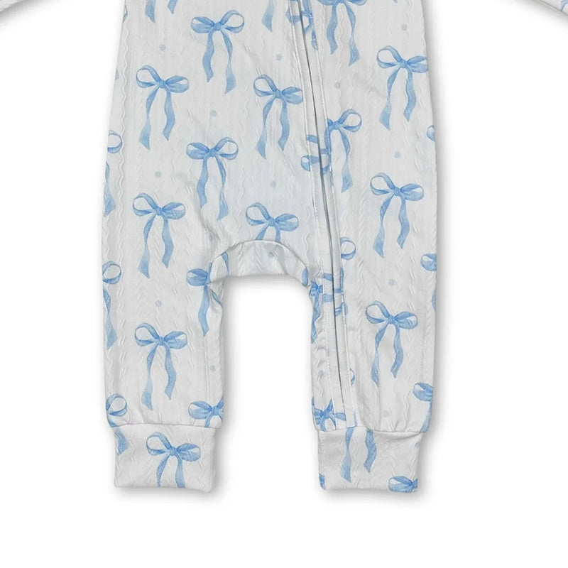 Detail view of the leg area of the Little Blue Bow zippered long sleeve romper, highlighting its cozy fabric and blue bow pattern.