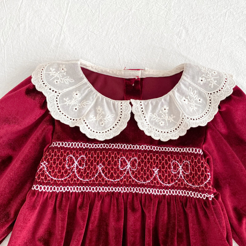 Deck the Halls Smocked Velvet and Frills Sibling Outfits - Deep Red; a detailed close-up of the lace collar and delicate smocking on the red velvet dress.
