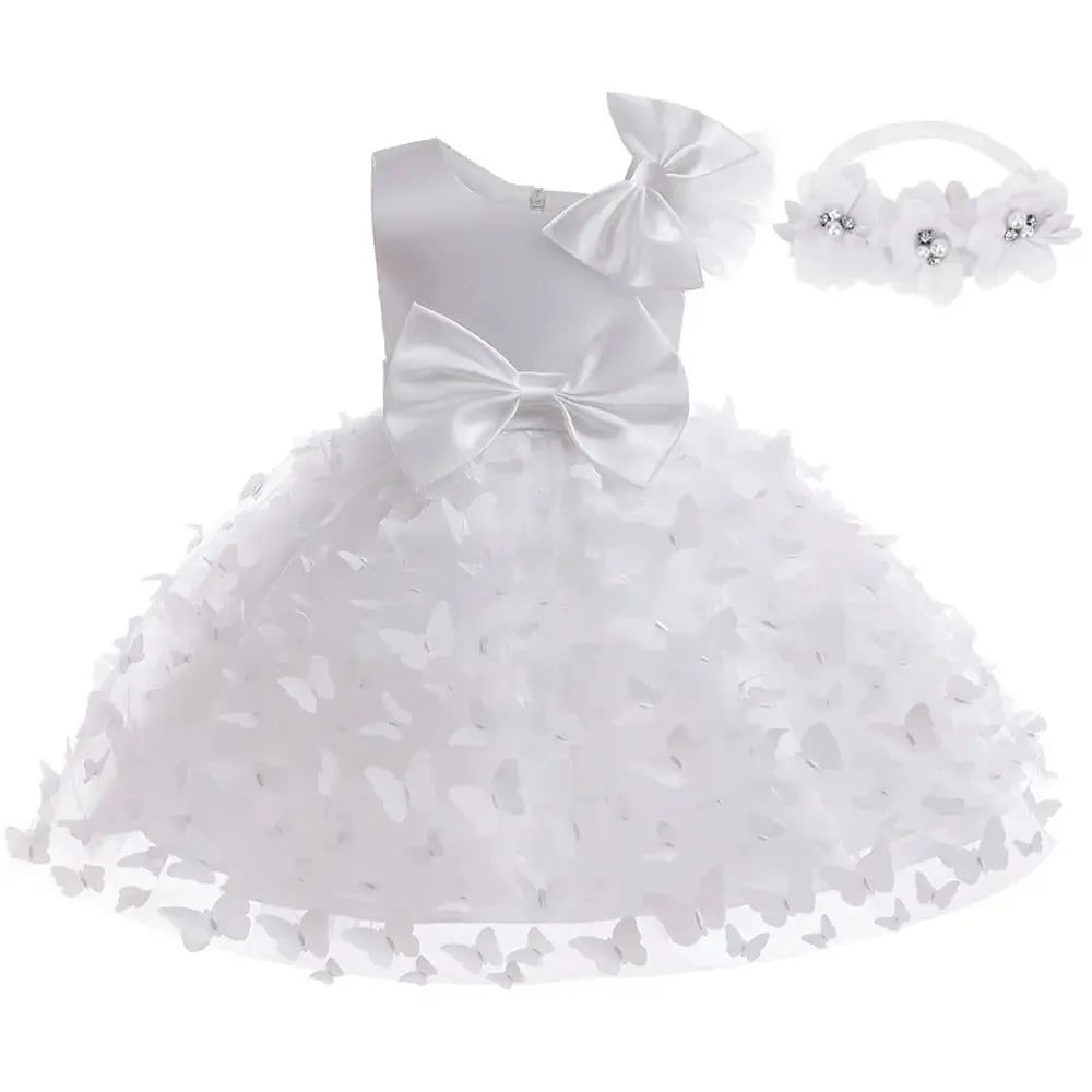 White butterfly-appliqué formal dress with satin bodice, large bow, and full tulle skirt; matching headband.