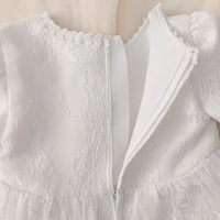 Tabitha elegant baptism flower girl dress in white lace, knee-length with zipper back, fitted bodice and flared skirt.