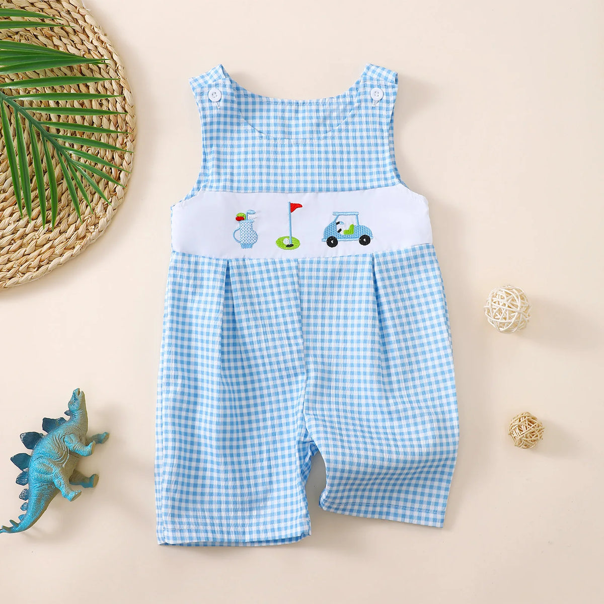 Blue and white gingham baby romper with golf-themed embroidery, sleeveless button closure design for toddler boys.