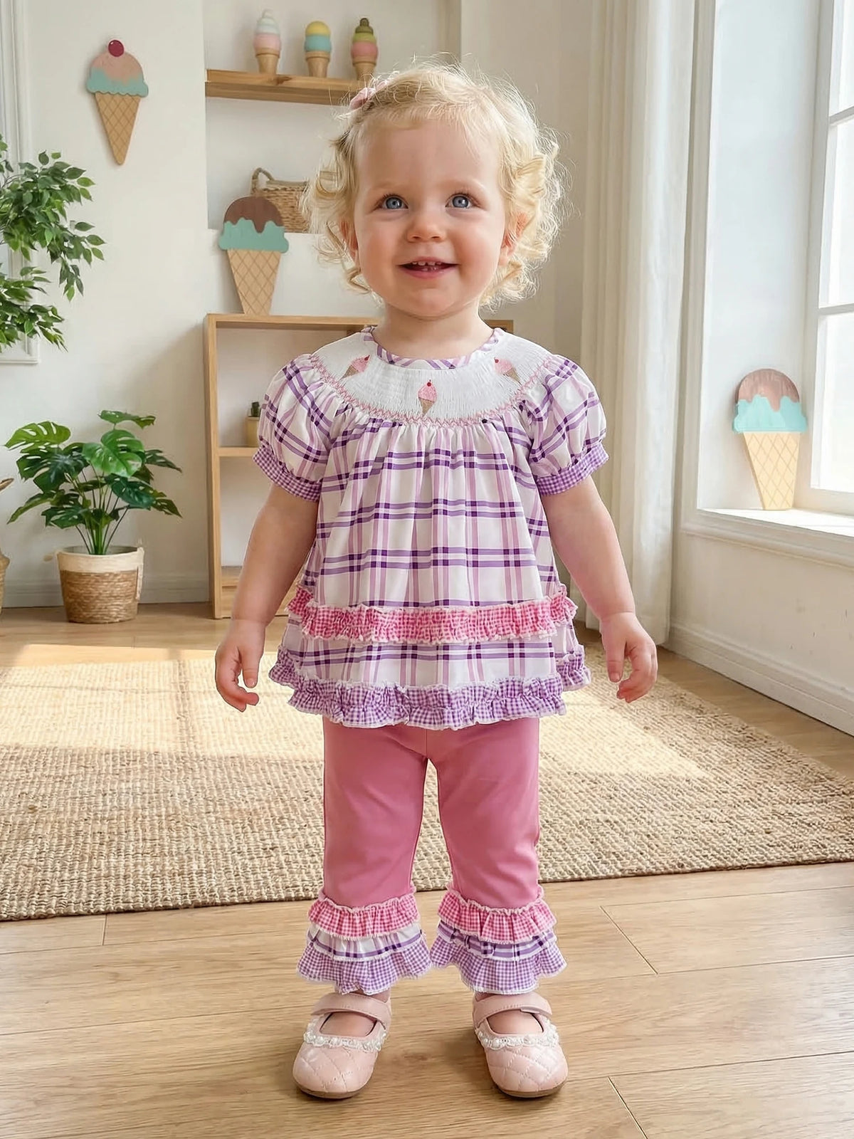Toddler girl in Frilly Boho Plaid Embroidered two-piece set: purple plaid top with puff sleeves and pink pants.
