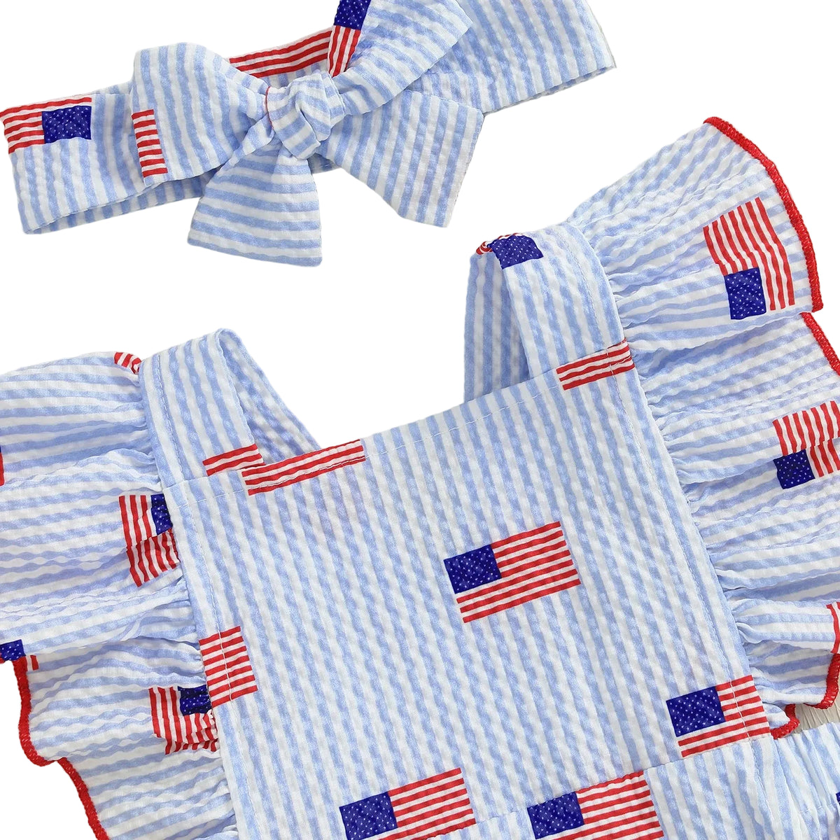 Children's outfit with blue and white striped pattern and American flag designs on a light background