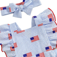 Children's outfit with blue and white striped pattern and American flag designs on a light background