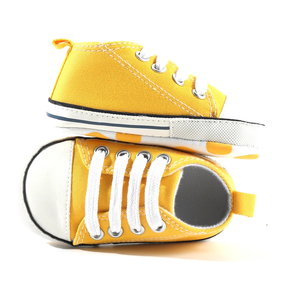 Baby's Canvas Lace-up First Walkers in Florida Sunshine Yellow with soft canvas uppers for comfort and breathability.