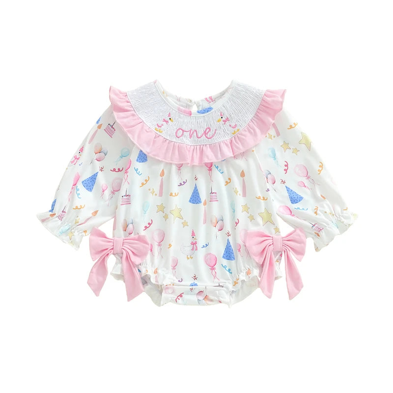 Baby romper with colorful patterns and pink accents on a white background