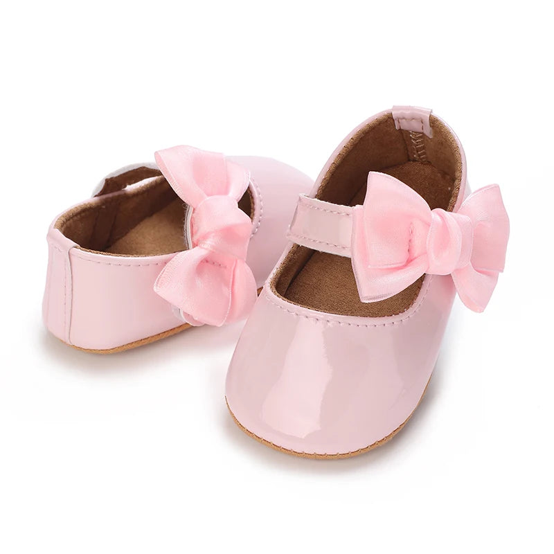 Serena Bow First Walker Shoes - Adorable pink Toddler shoes adorned with a charming bow, ideal for little girls learning to walk.