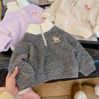 Children's gray fleece pullover with embroidered horse detail and cream collar, shown with purple and pink options for cozy fall wear.