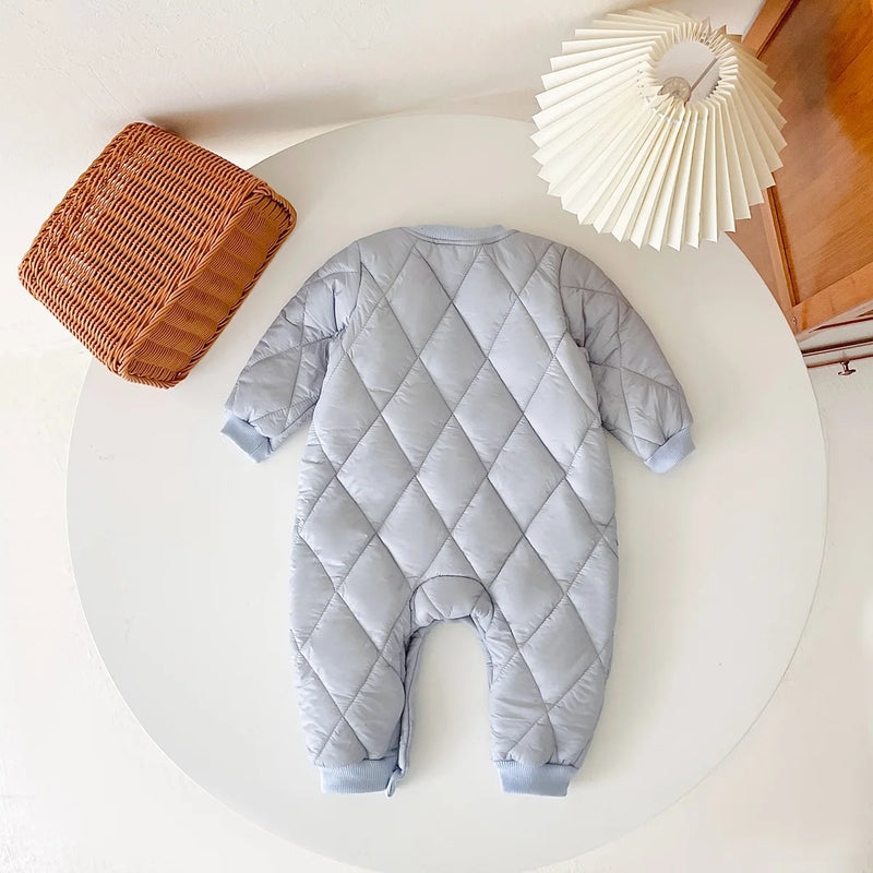 Back view of a soft light blue baby quilted romper, emphasizing its quilted design for added comfort.