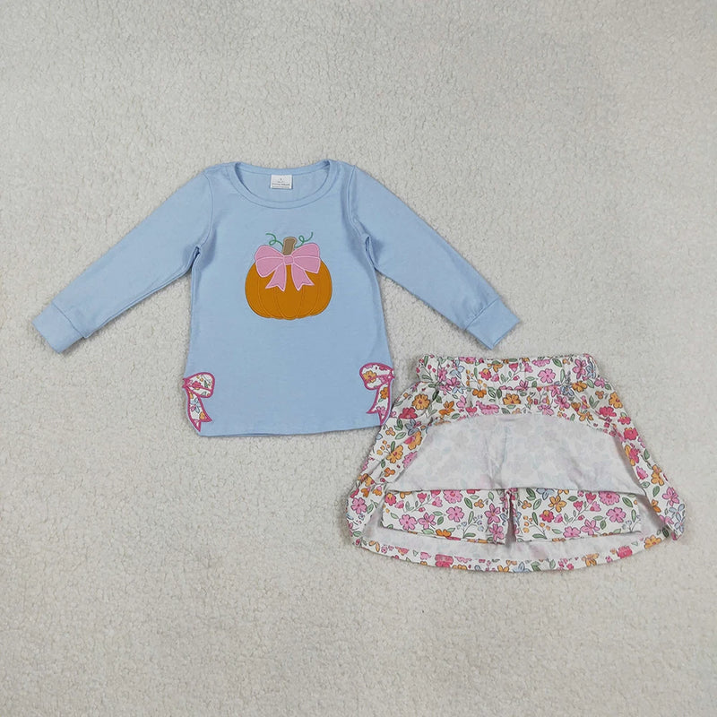 Full view of the Pumpkin Fleurs Baby Girls' Embroidered Skort Outfit showcasing the embroidered pumpkin top and floral skort with built-in shorts.