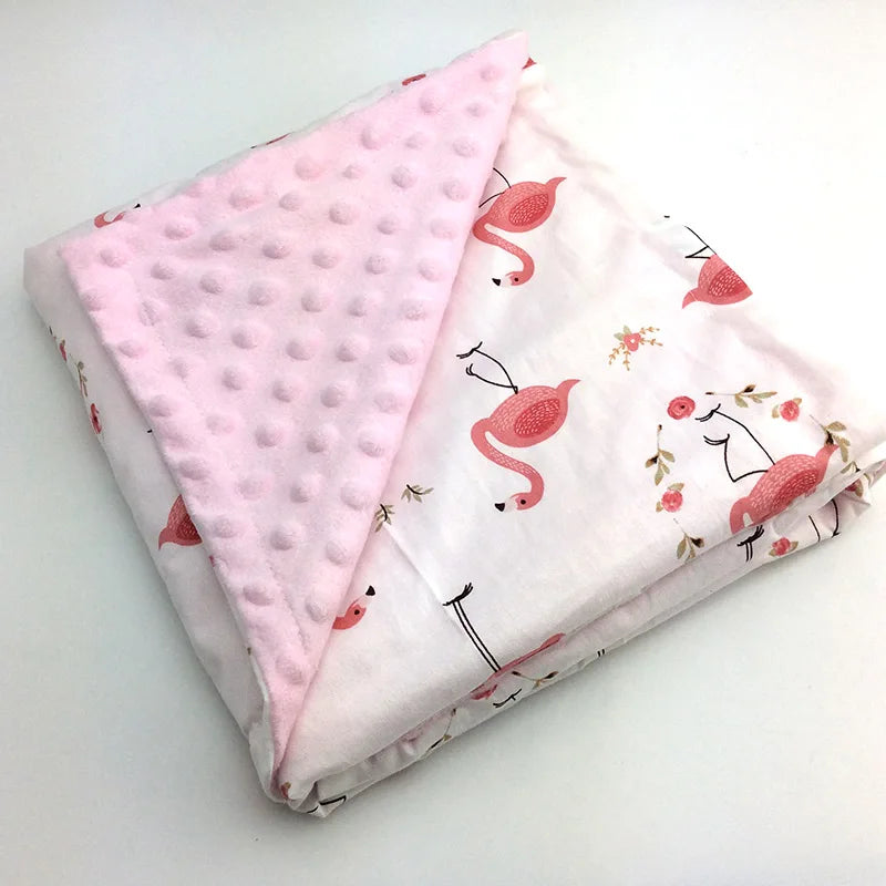 Two-sided children's minky blanket with pink raised-dot side and flamingo print.