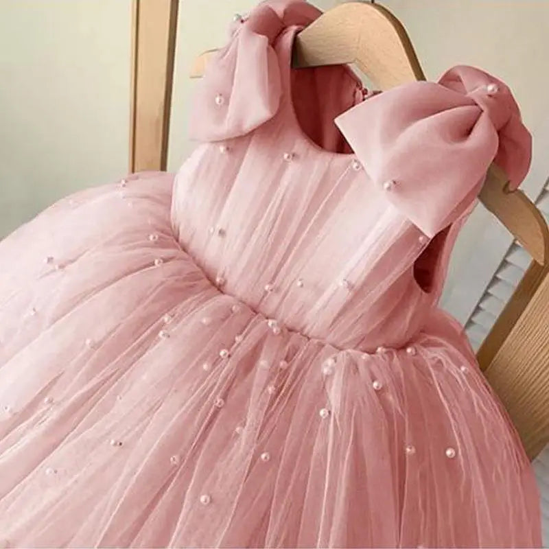 Daria Tulle and Pearls Party Dress in pink with pearl beads and shoulder bows, sleeveless tulle gown.